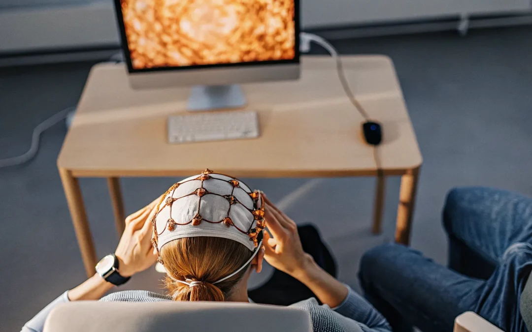 Person receiving neurofeedback for addiction with an EEG cap monitoring brainwaves.